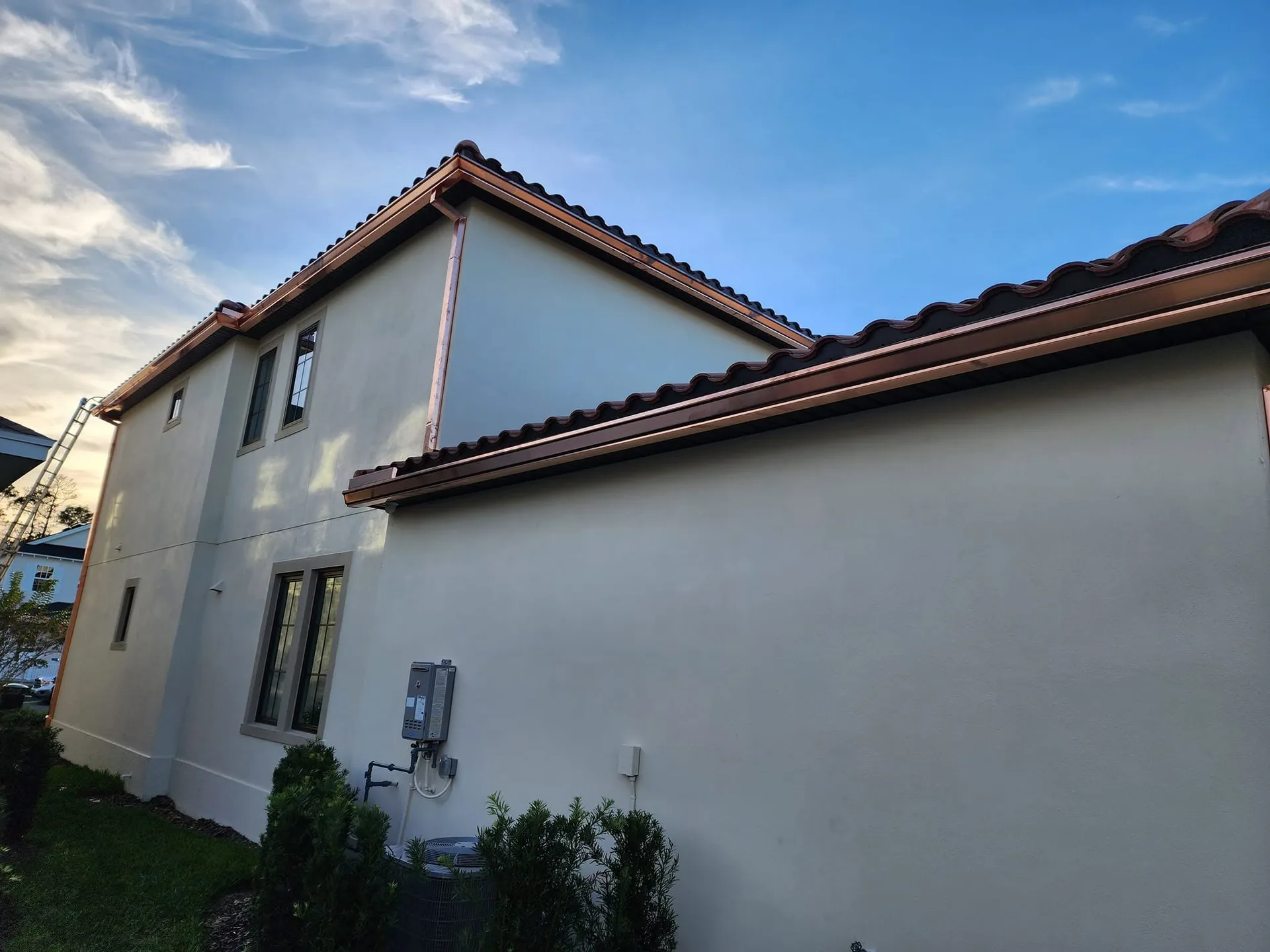 Copper k style gutters cream stucco side elevation tankless heater, Sanford